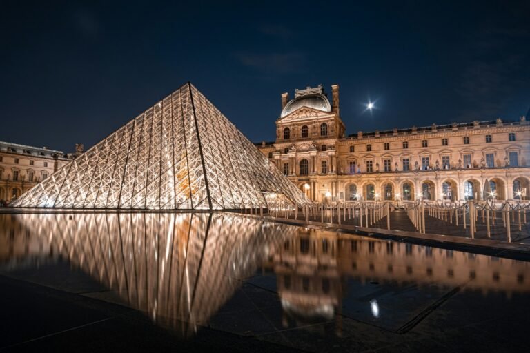 The Louvre pyramid lit up at night