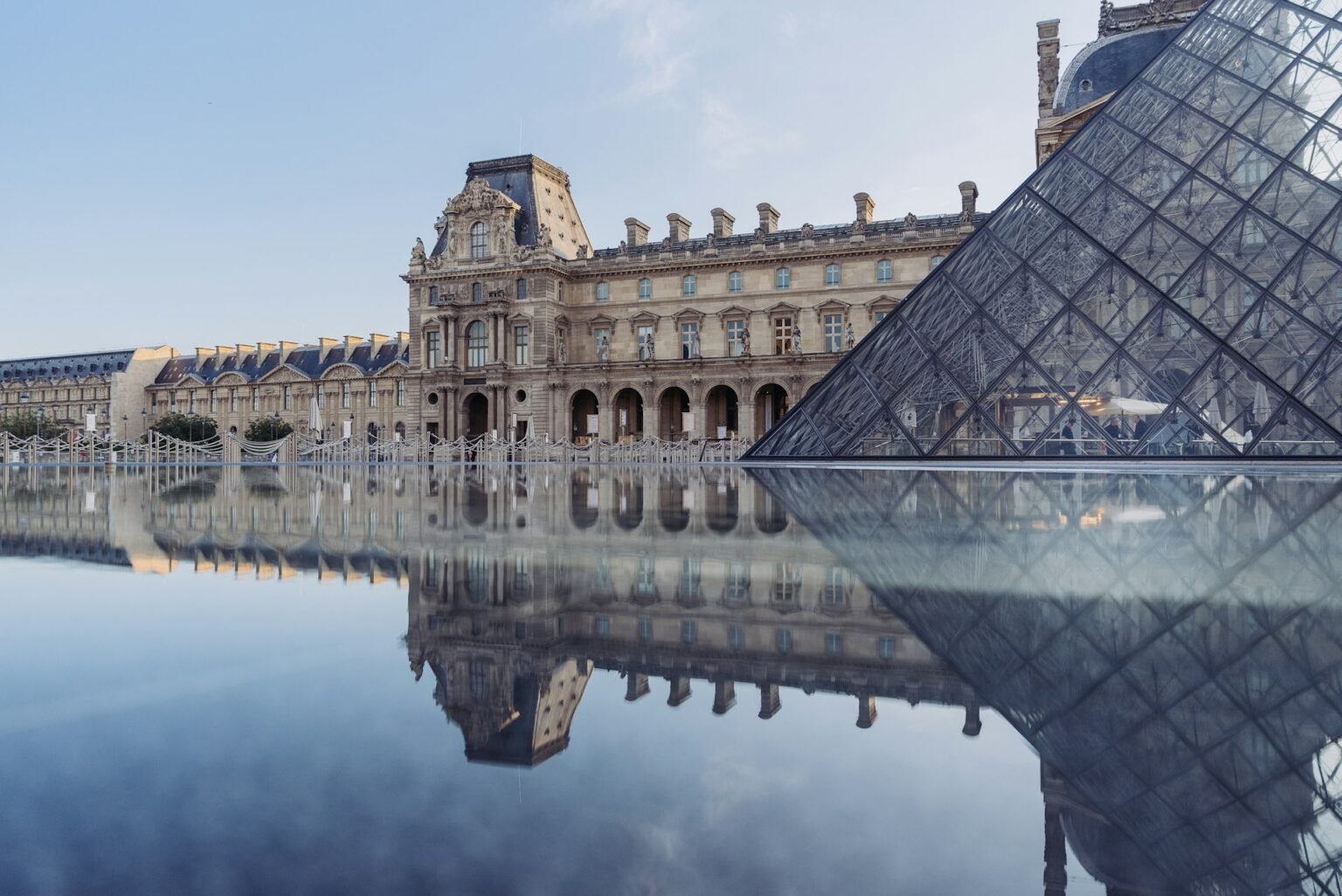 The Louvre reflected in a pool beside the glass pyramid